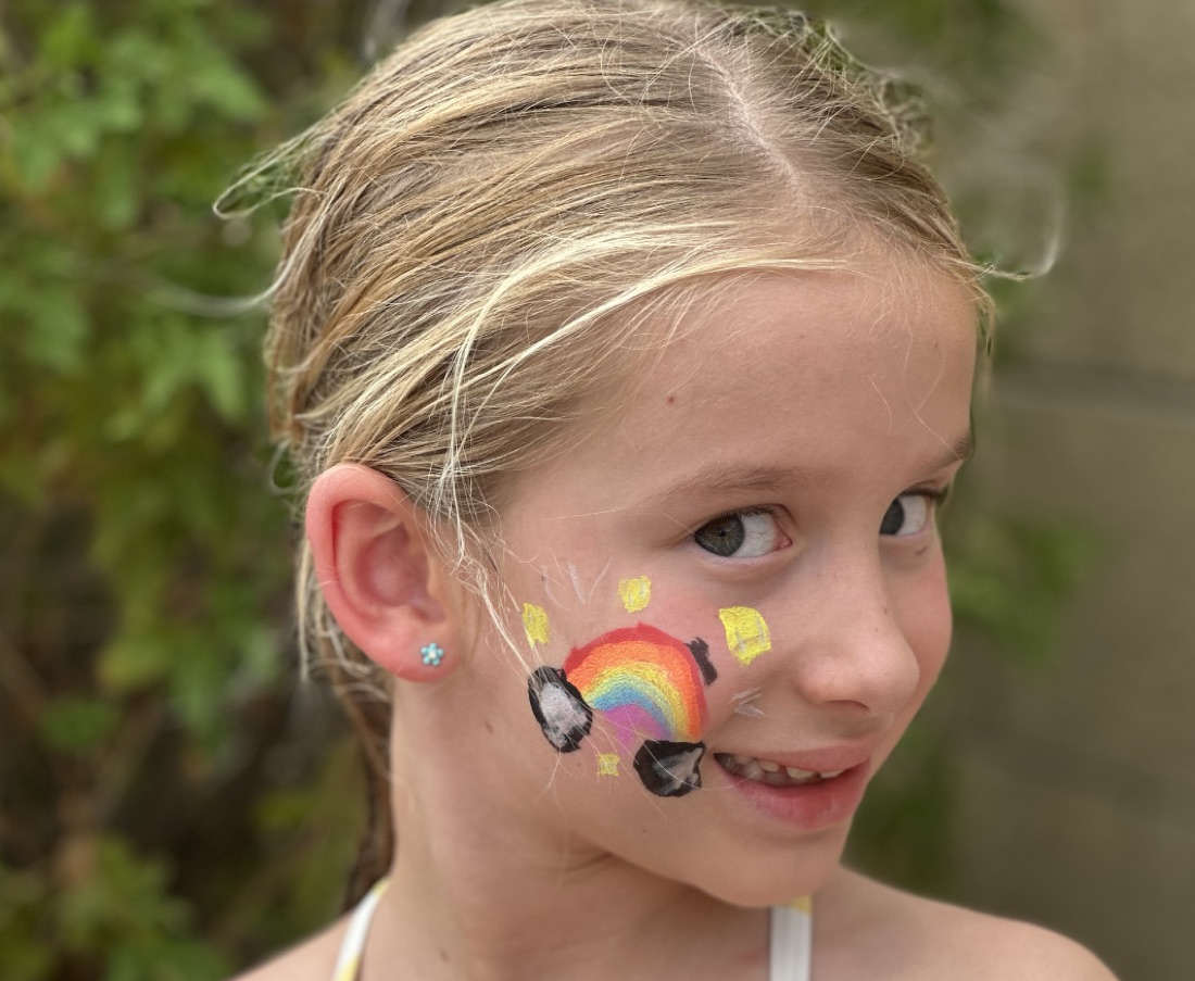 Rainbow cheek face paint design